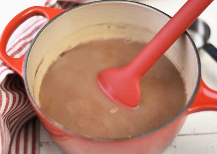 peppermint hot cocoa with milk and cream in pot