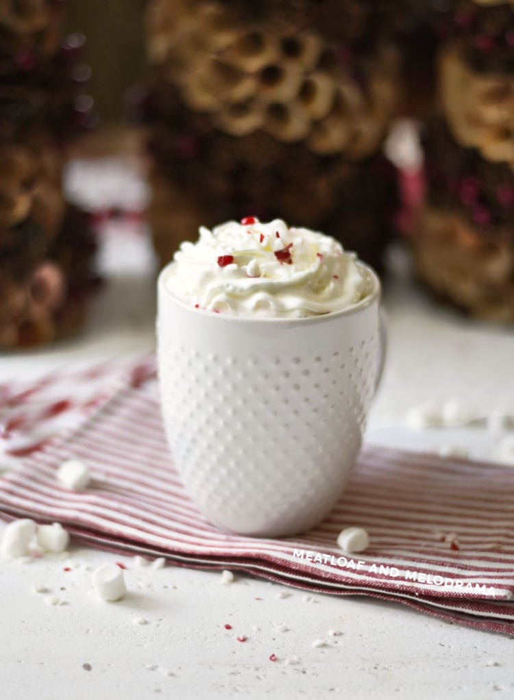 homemade peppermint hot cocoa with whipped cream in white mug