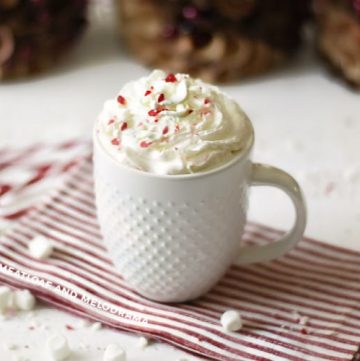 peppermint hot cocoa with whipped cream in a white mug