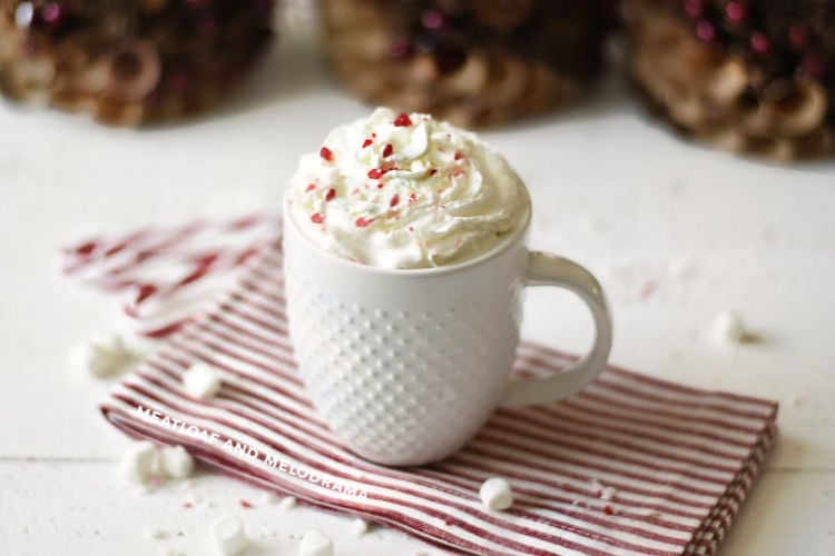 peppermint hot cocoa with whipped cream in a white mug