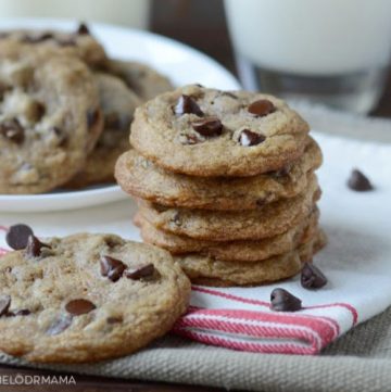 best chocolate chip cookies stacked on a plate with milk