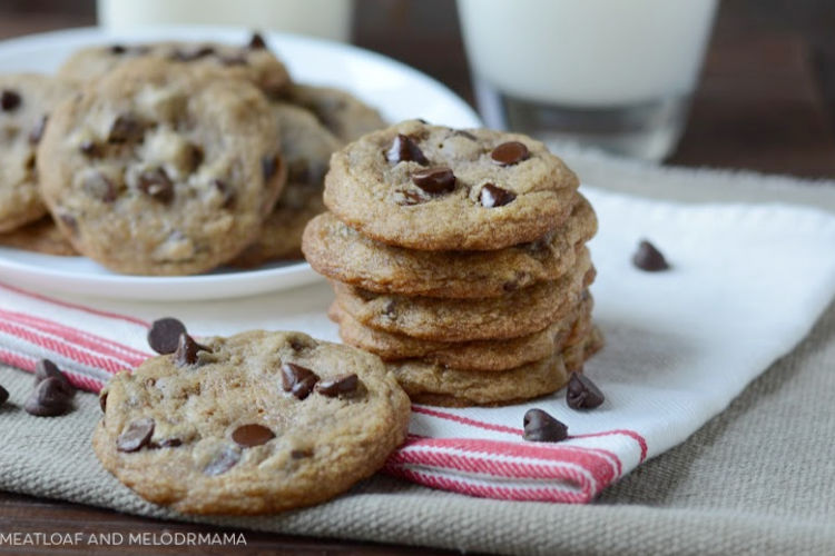 best chocolate chip cookies stacked on a plate with milk