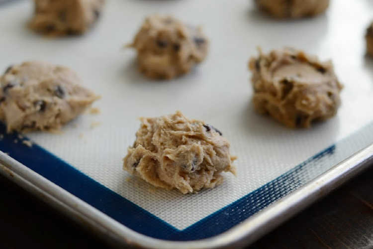 chocolate chip cookie dough on baking sheet