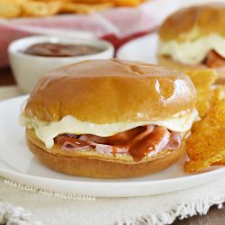 baked ham and cheese sliders with bbq sauce and melted provolone cheese