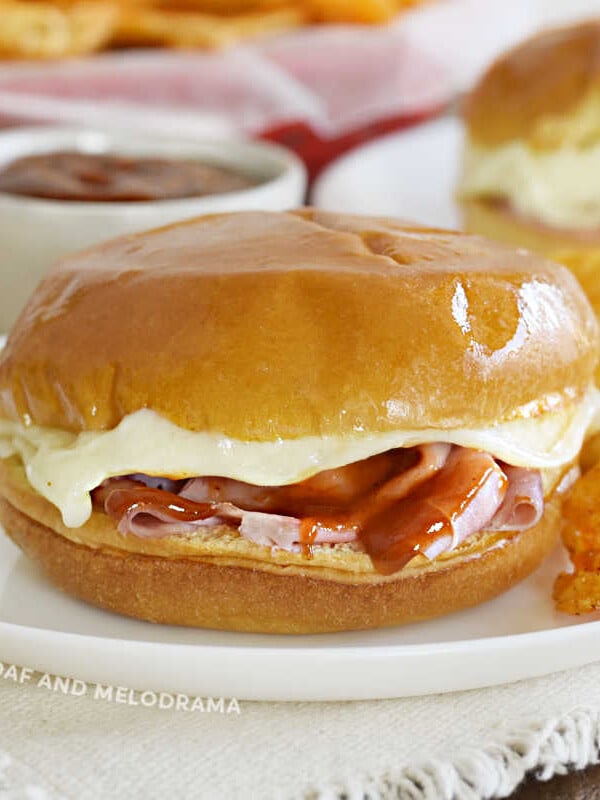 baked ham and cheese sliders with bbq sauce and melted provolone cheese
