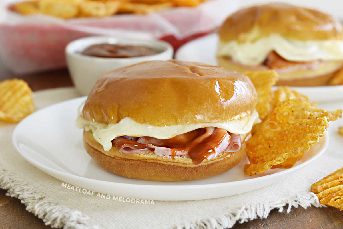 baked ham and cheese sliders with bbq sauce and melted provolone cheese