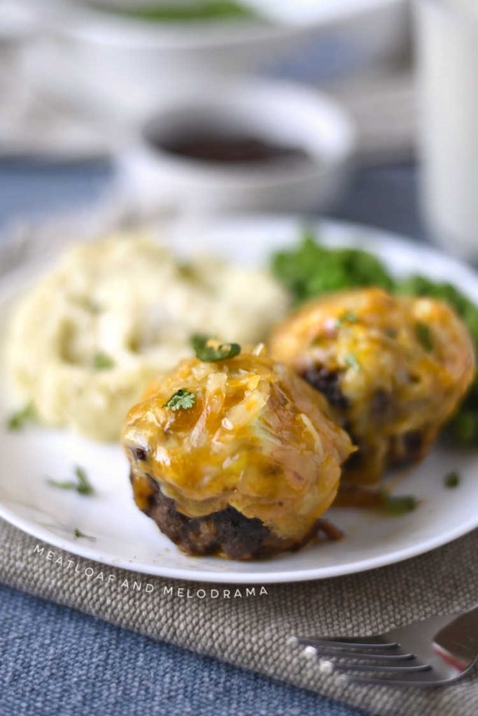 cheddar bbq meatloaf muffins with mashed potatoes on a white plate