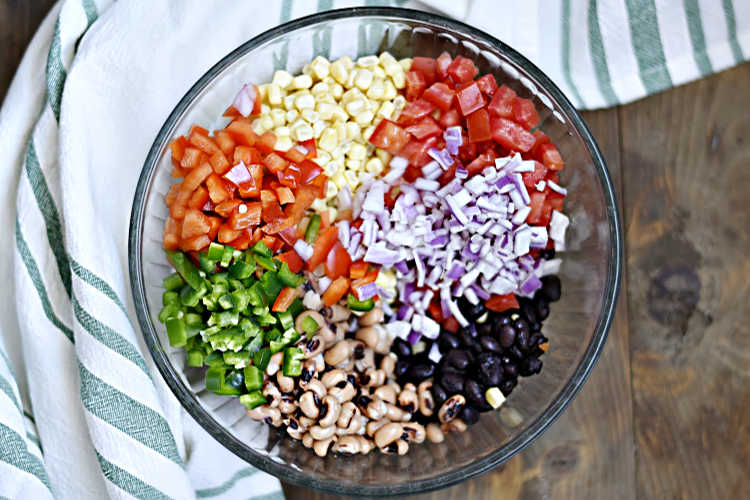 ingredients for cowboy caviar in mixing bowl