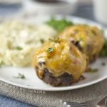 mini meatloaf muffins with cheddar cheese and bbq sauce on a plate