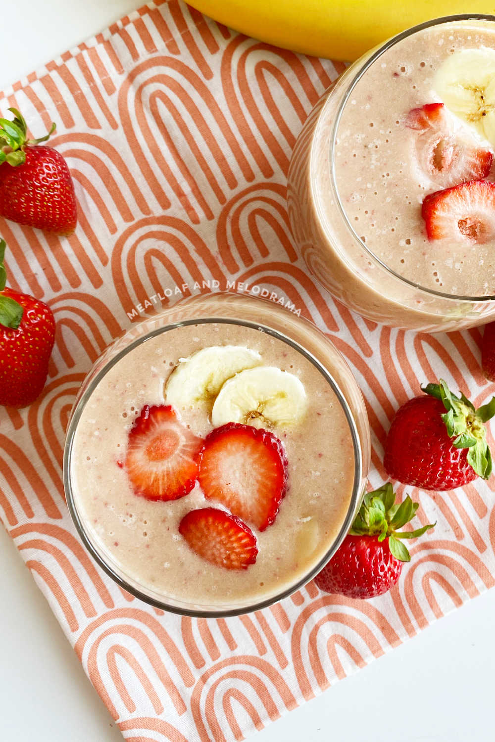 overhead view of strawberry banana protein smoothie in glasses