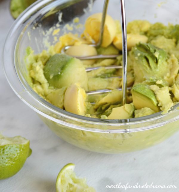 mash avocado and hard boiled eggs in bowl