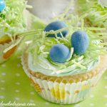 easter cupcakes topped with edible grass and chocolate candy eggs in a nest