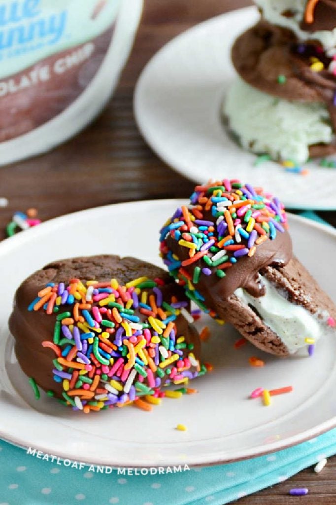 mint chip ice cream cookie sandwiches with sprinkles on a white plate