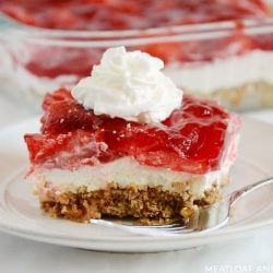 strawberry pretzel salad on a white plate