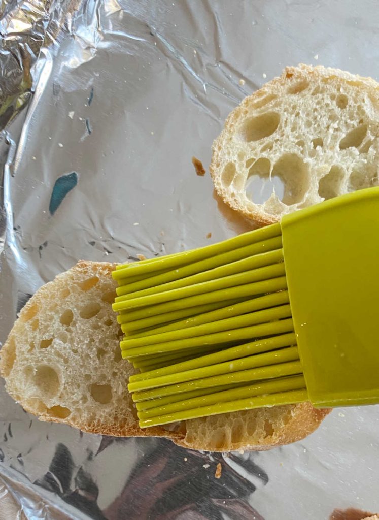 brush baguette slices with melted garlic butter