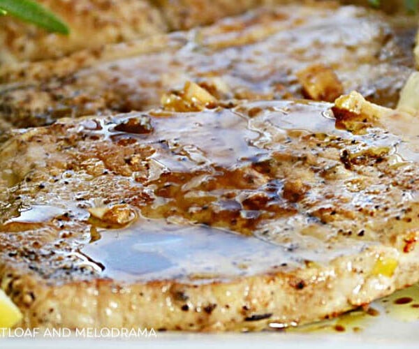 grilled boneless pork loin chops with garlic lemon and rosemary and balsamic glaze on platter