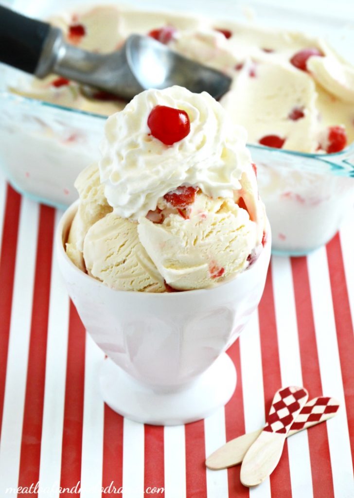 cherry vanilla ice cream with whipped
cream in a white dish 