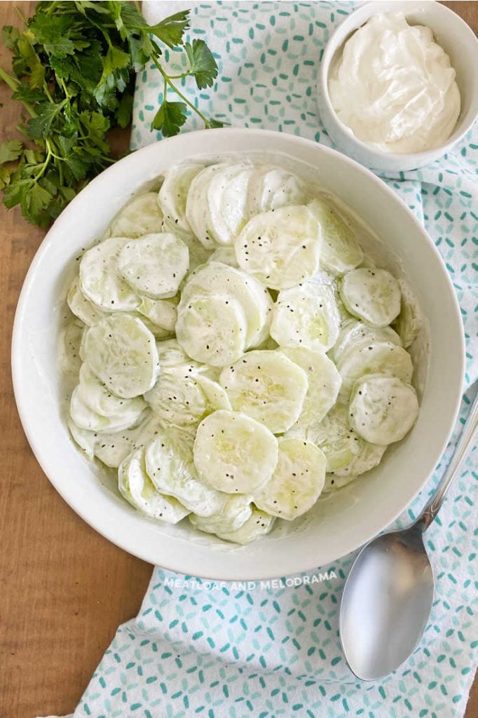 cucumber salad with sour cream in a white bowl