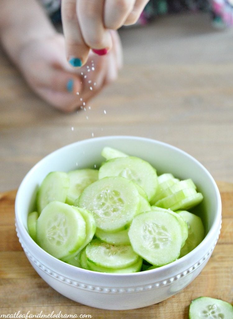sprinkle sea salt over sliced cucumbers