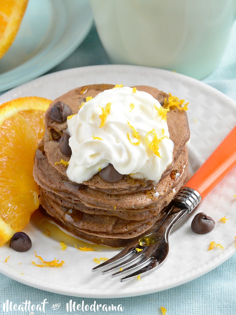 chocolate orange pancakes with whipped cream on plate