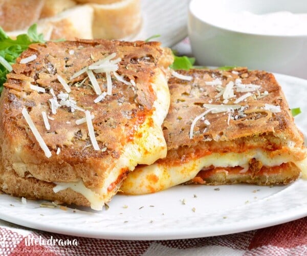 Parmesan crusted pepperoni pizza grilled cheese sandwich on plate