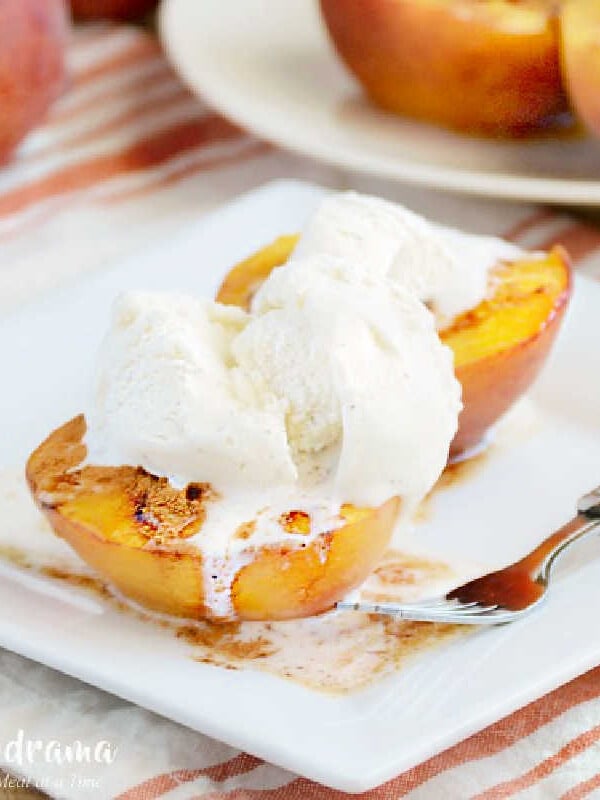 brown sugar cinnamon baked peaches on plate with ice cream