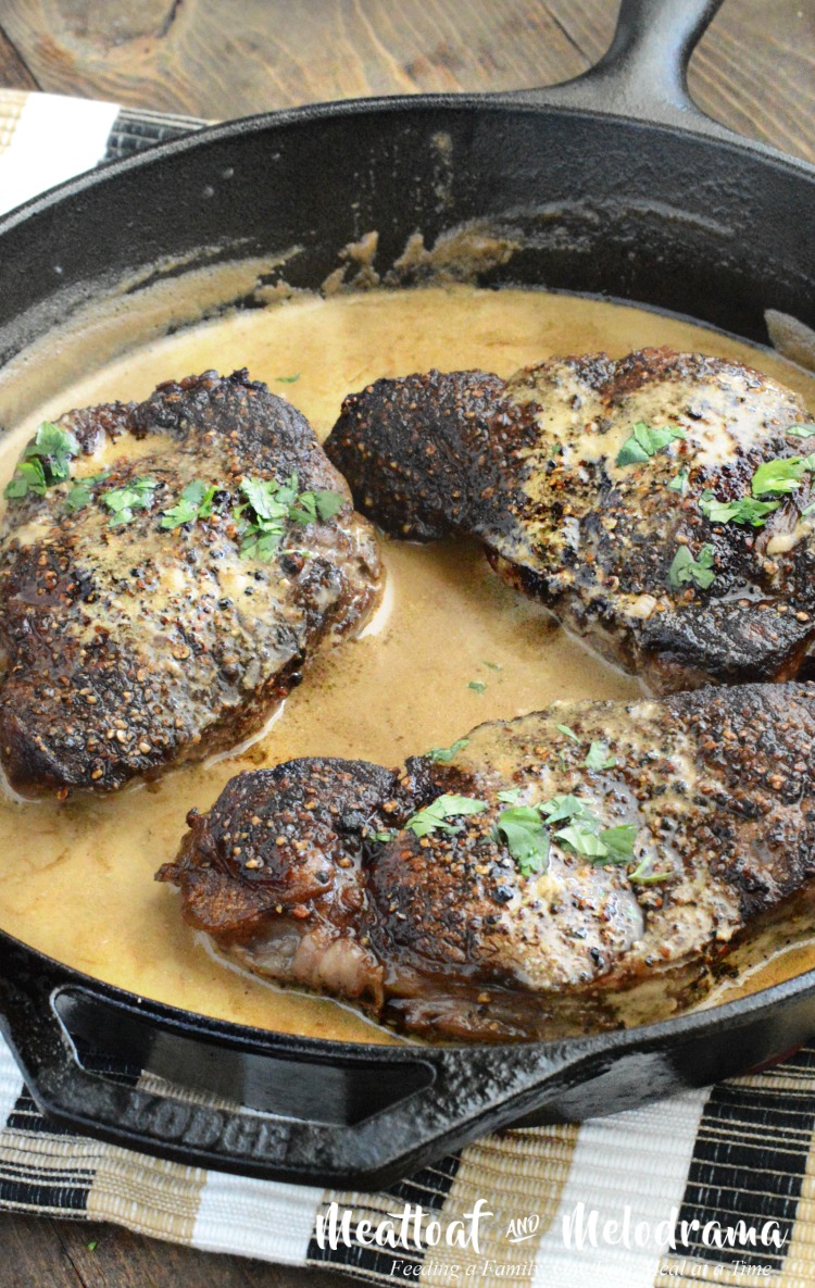 easy steak au poivre in bourbon dijon cream sauce in cast iron pan