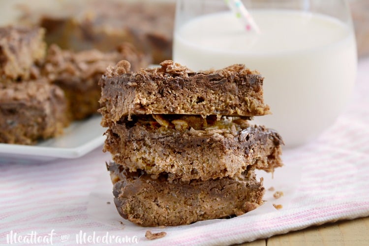 no bake chocolate peanut butter cereal bars plated with milk glass