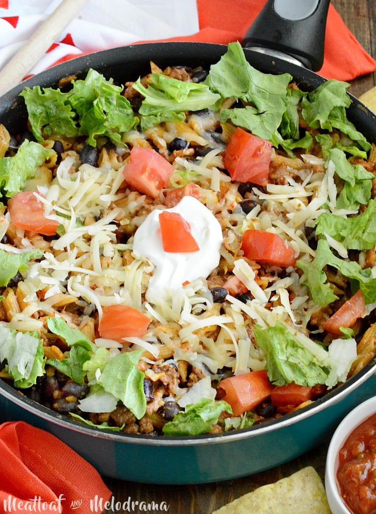 one pot easy taco pasta skillet with tomatoes lettuce and sour cream
