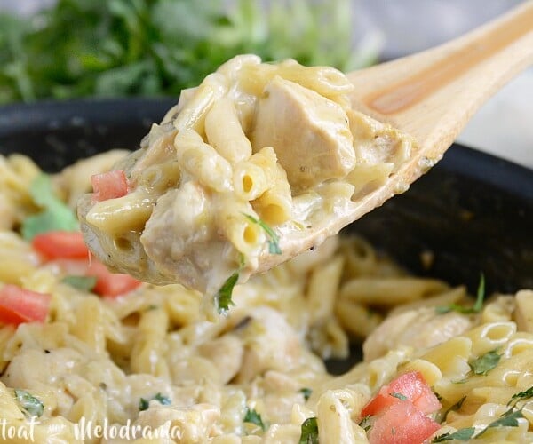 one pot salsa verde chicken pasta on wooden spoon