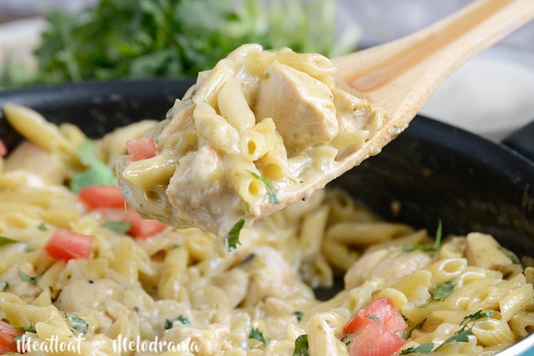 one pot salsa verde chicken pasta on wooden spoon