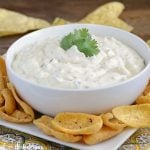 creamy salsa verde dip in bowl with chips