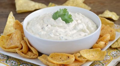 creamy salsa verde dip in bowl with chips