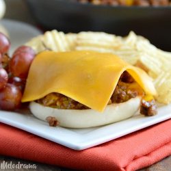 open faced sloppy joes with cheddar cheese on english muffins