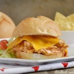 crock-pot enchilada chicken sliders with cheddar cheese on plate