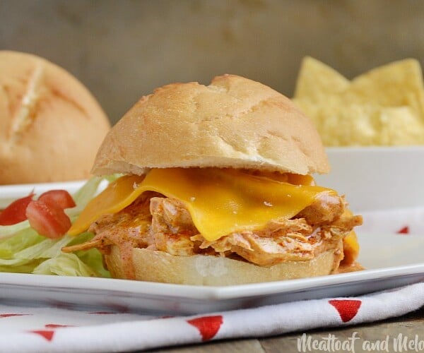 crock-pot enchilada chicken sliders with cheddar cheese on plate
