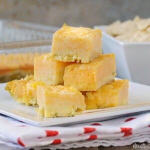 green chile cheese squares appetizer on a white square plate