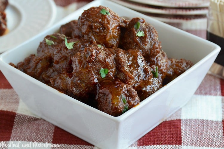 homemade cocktail party meatballs with tangy red sauce in serving dish