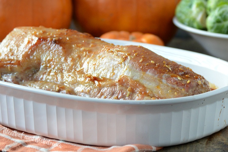 maple mustard pork roast in white baking dish