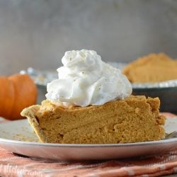 no-bake pumpkin cheesecake pie on plate with whipped cream