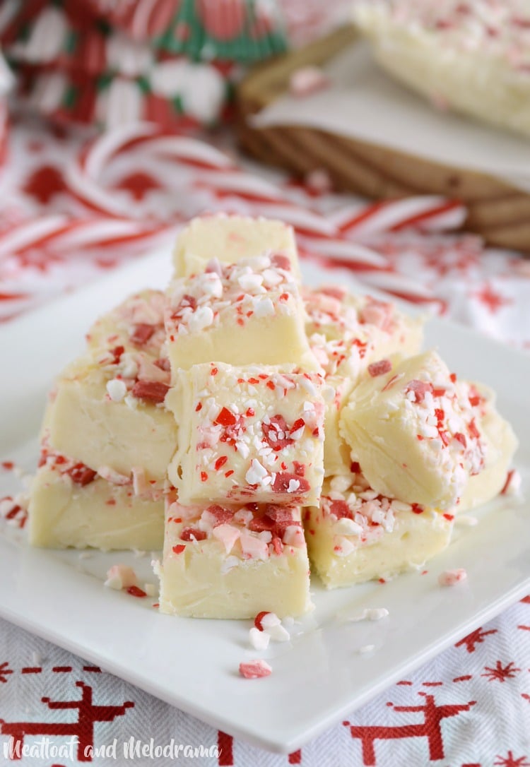 white chocolate peppermint fudge topped with peppermint candies on plate
