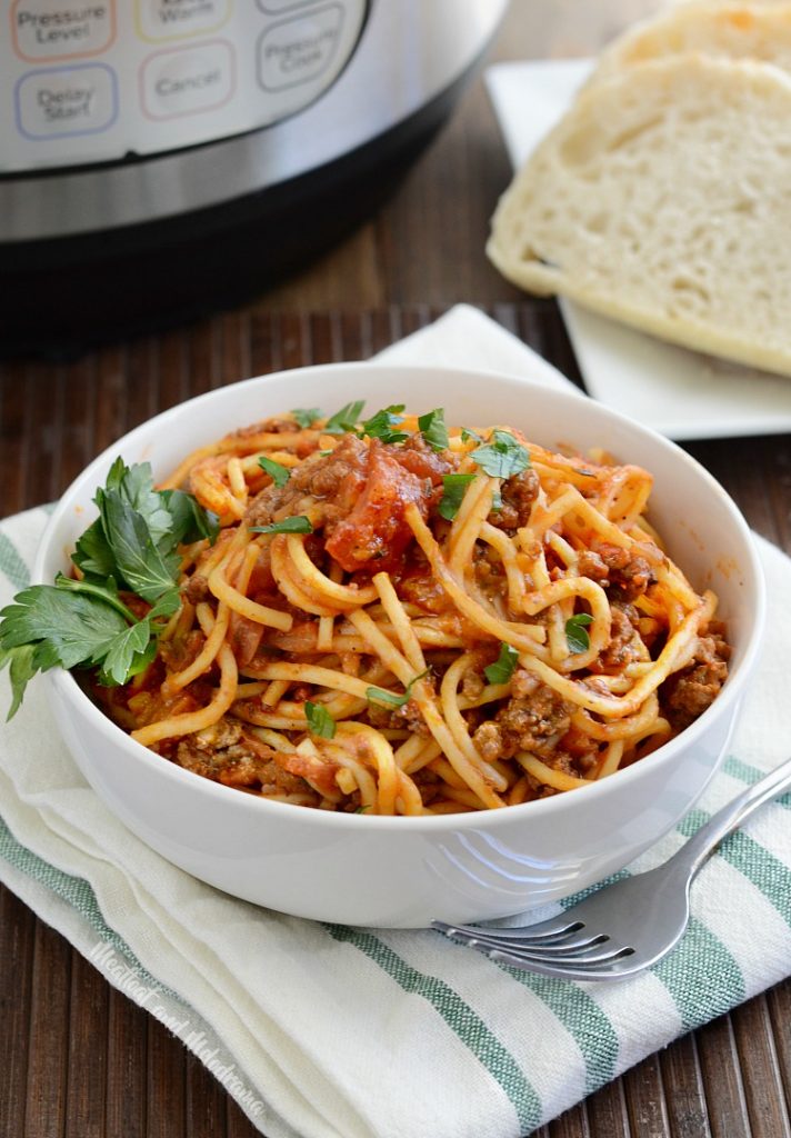 instant pot spaghetti and meat sauce in bowl with side of bread
