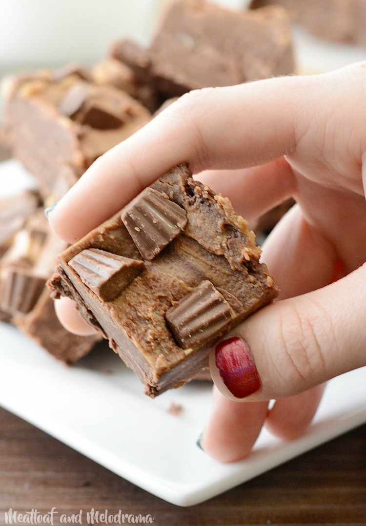 easy chocolate peanut butter fudge with Reese's candy on top in hands