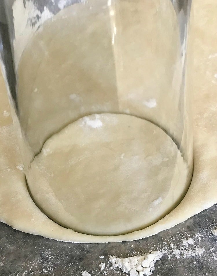 cut homemade pierogi dough with glass