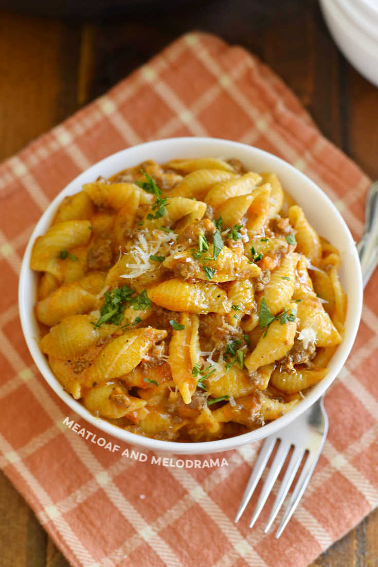 shell pasta and beef in tomato sauce a white serving bowl