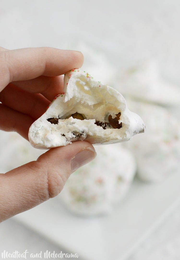 meringue chocolate chip cookies cut open with chocolate chips inside
