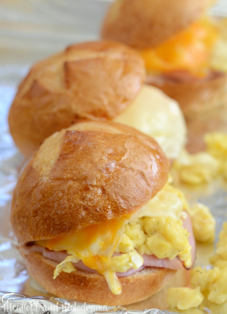 baked cheesy ham and egg breakfast sliders on baking sheet 