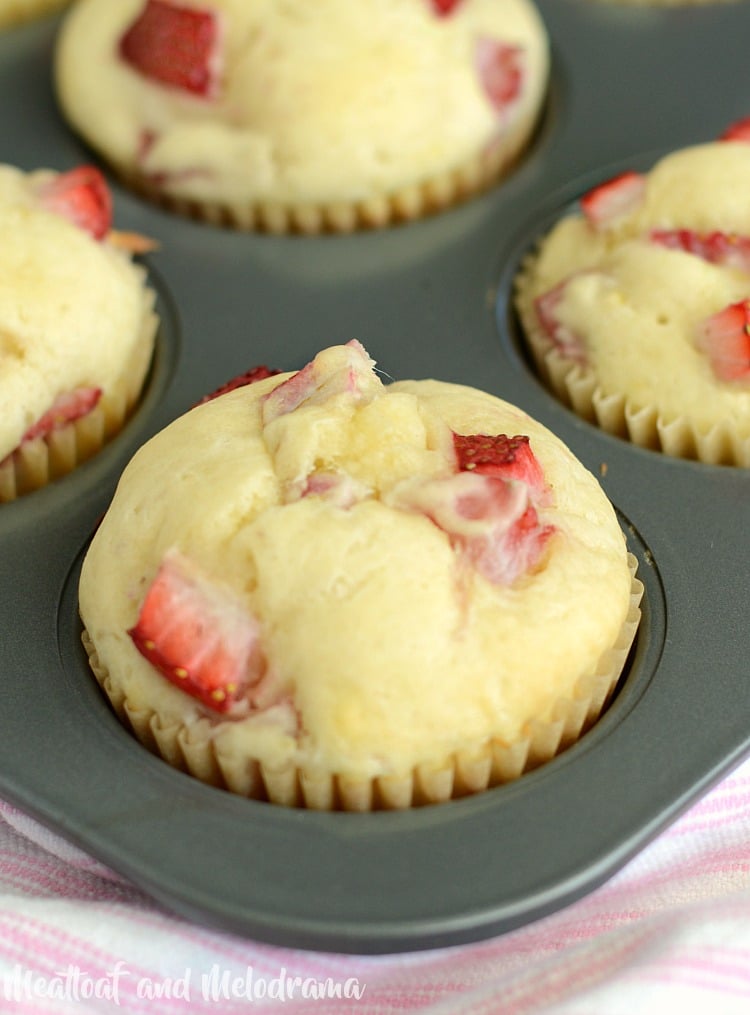 glazed lemon strawberry muffins in muffin tin