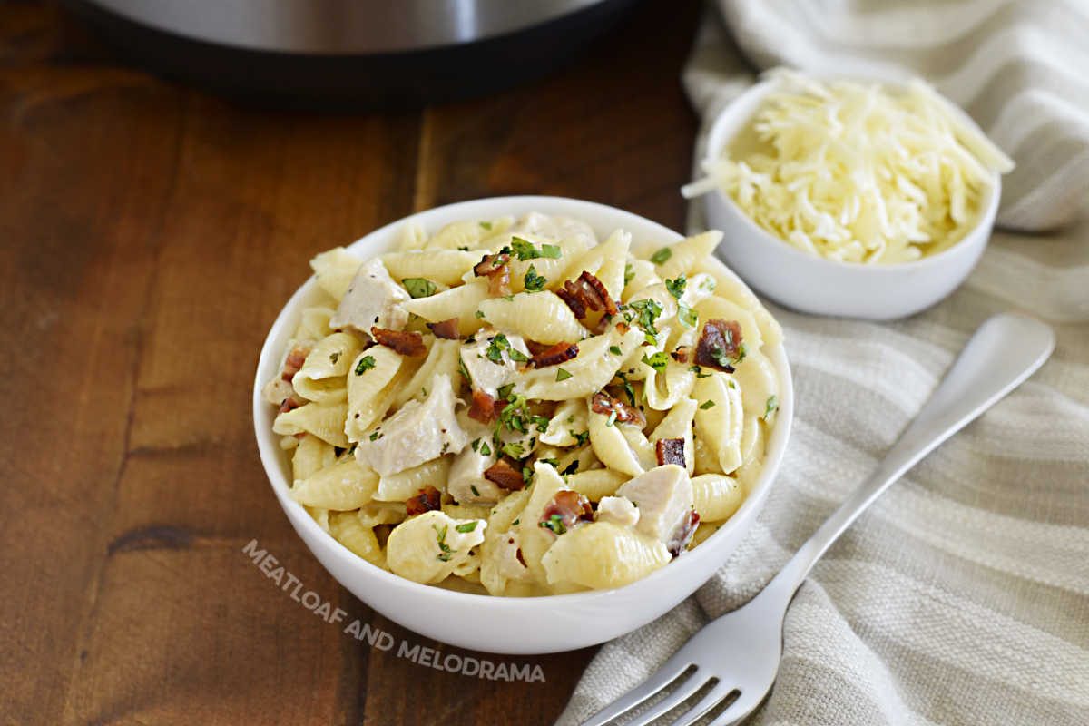 instant pot creamy chicken bacon ranch pasta in bowl with parsley on top