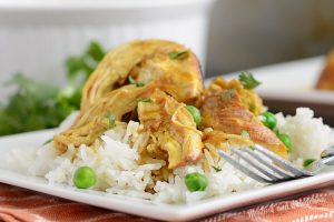 instant pot honey mustard curry chicken over jasmine rice on a plate